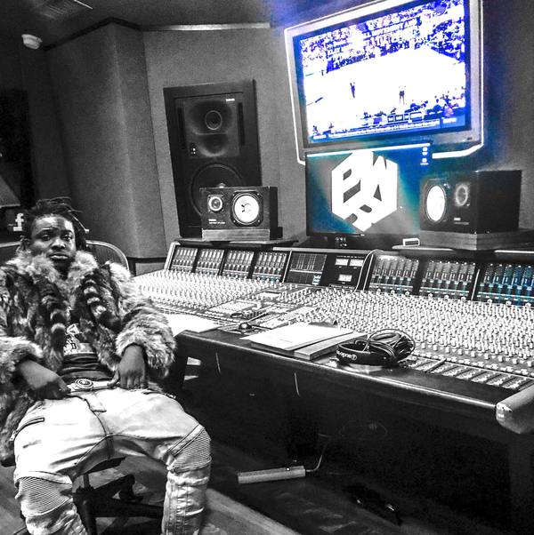 coolyonthebeat, founder and producer of Ocean Blue Recording, at a large-format mixing console in the studio