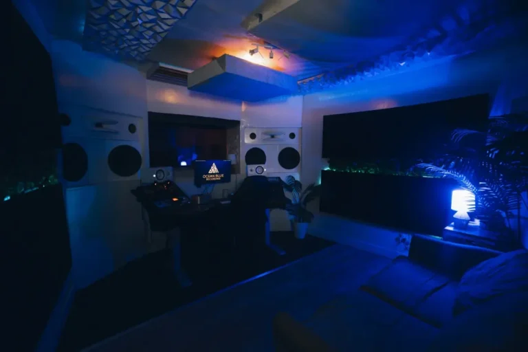 Wide view of the Ocean Blue Recording control room near Atlanta with producer desk, monitors and a client couch under blue lighting