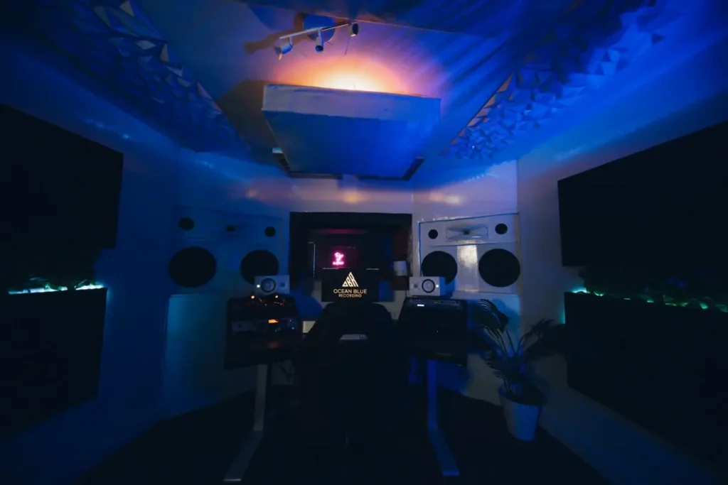 Control room at Ocean Blue Recording, a professional recording studio in Decatur, GA, with soffit-mounted monitors, producer desk and the studio logo on screen
